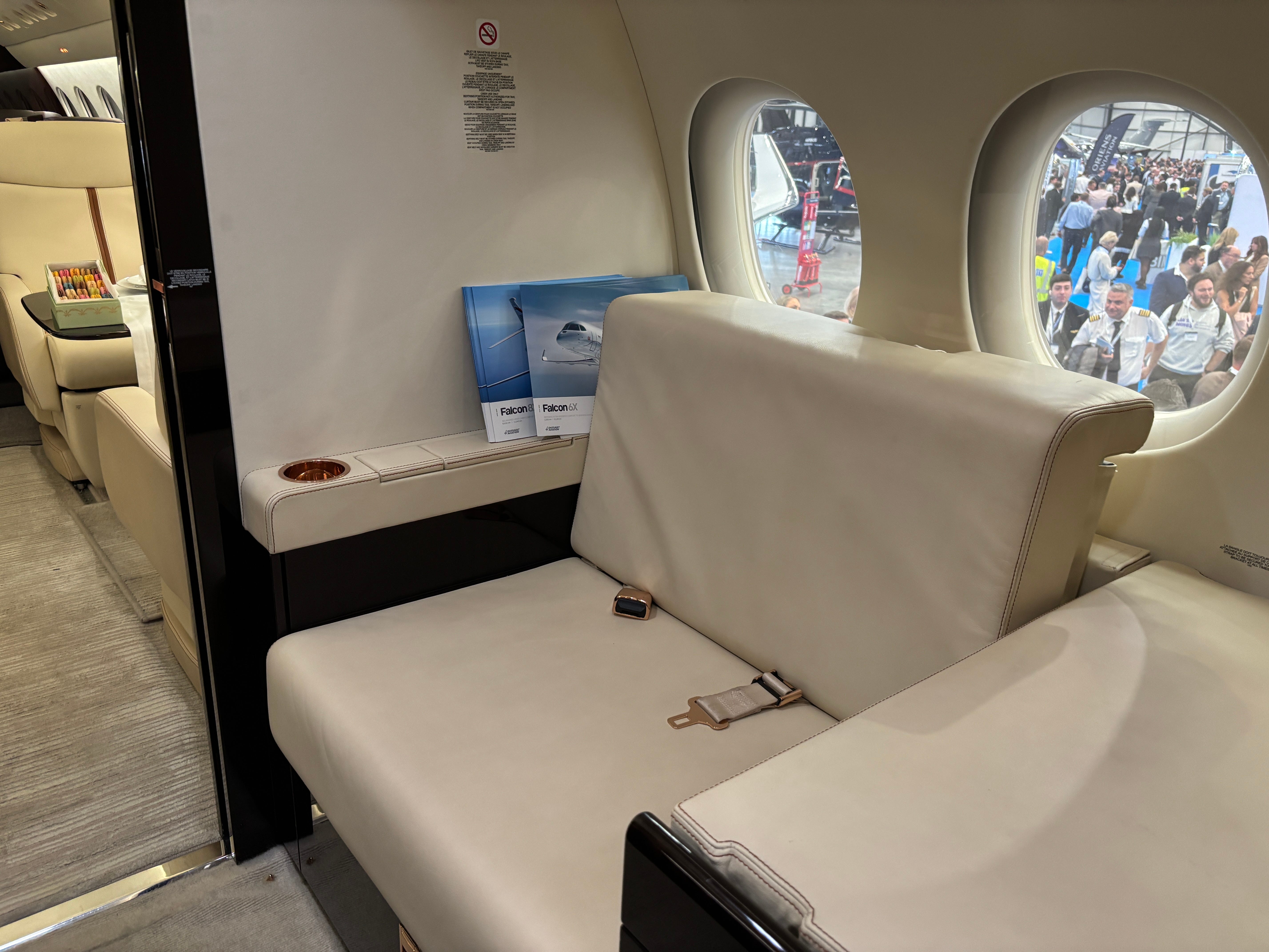 One seat, usually for crew, at the front of a Dassault Falcon 8X on display at the 2025 Air Charter Expo