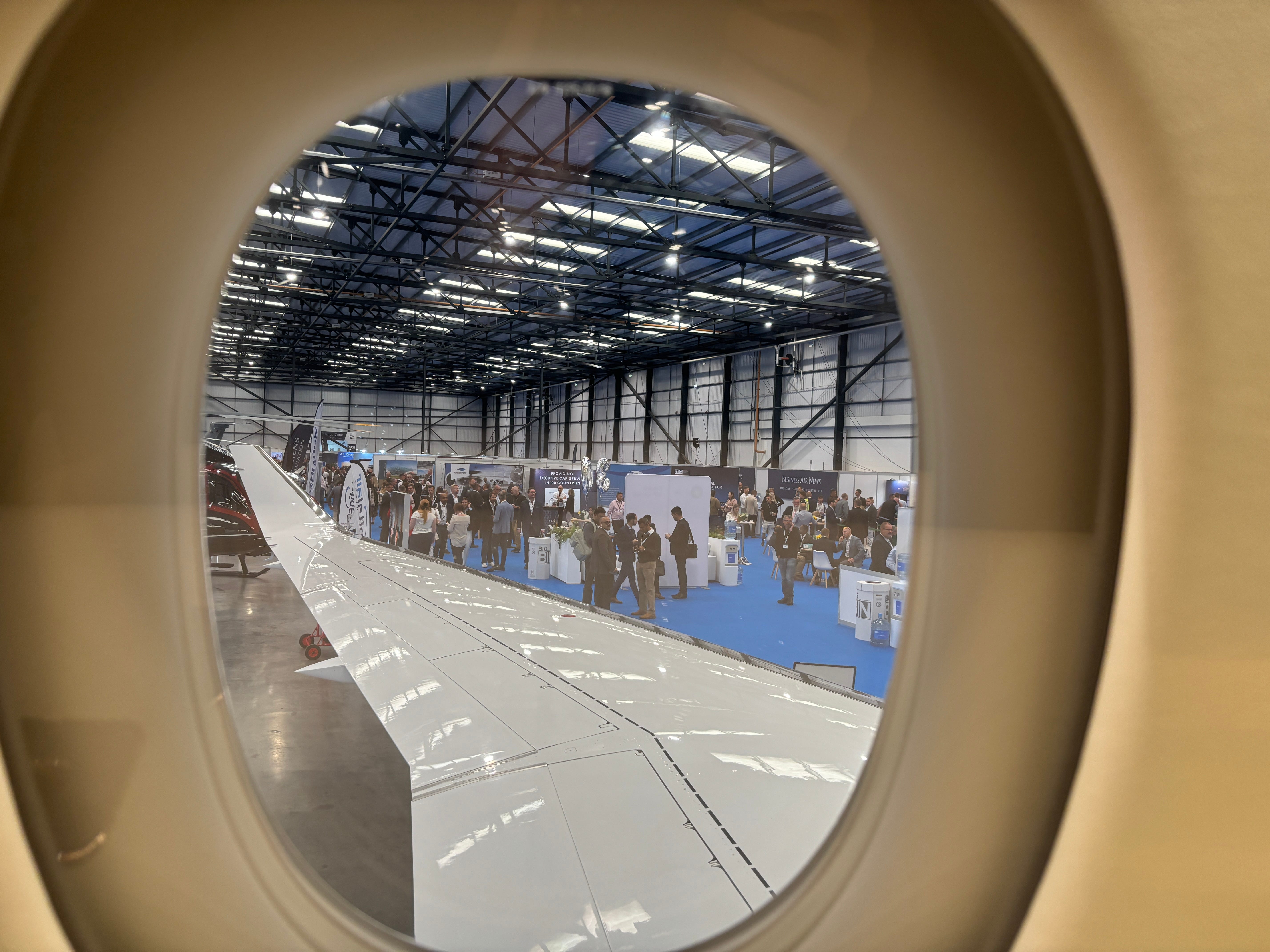 A view of the wing out the window of a Dassault Falcon 8X on display at the 2025 Air Charter Expo