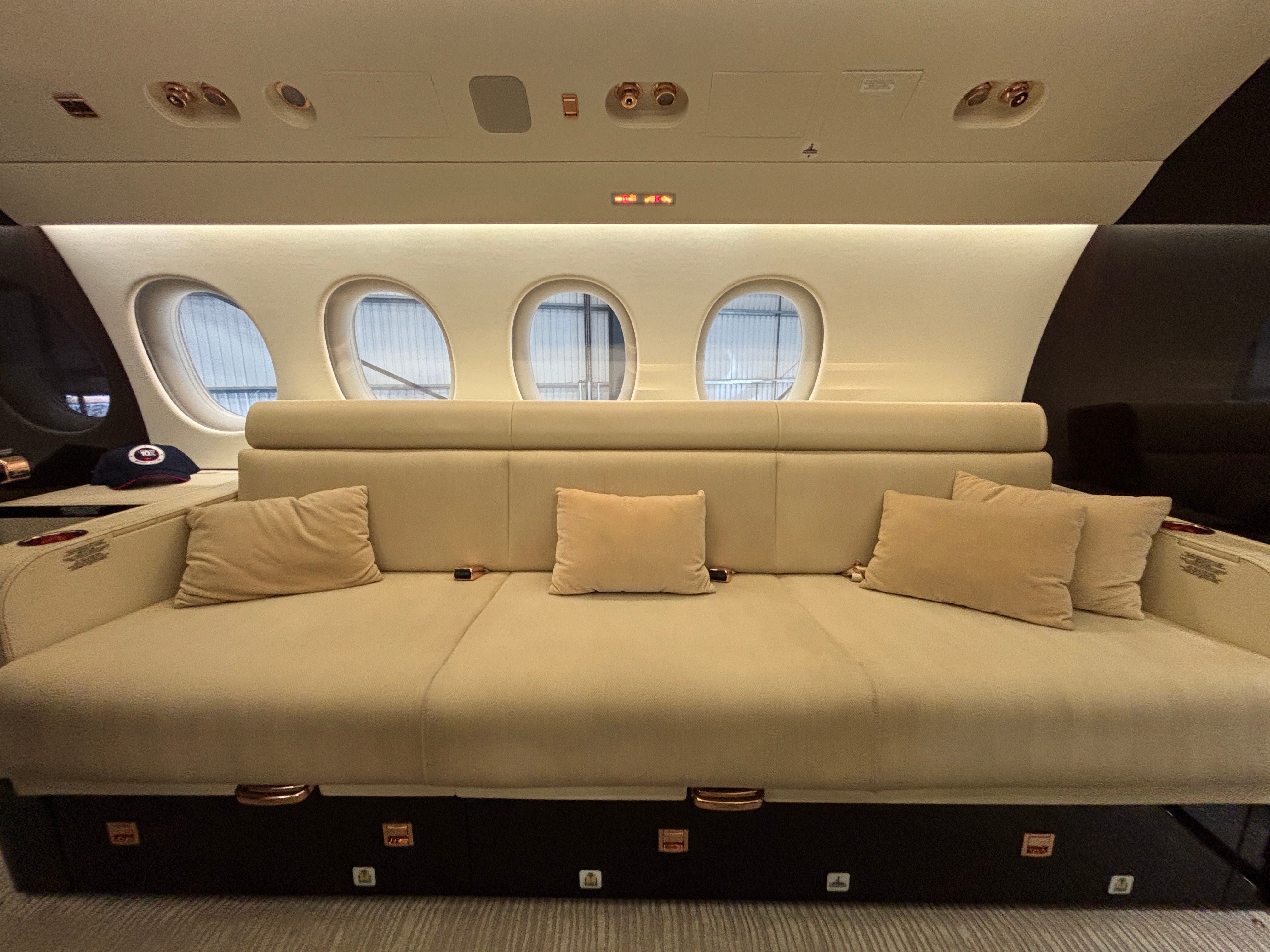 A sofa at the rear of a Dassault Falcon 8X on display at the 2025 Air Charter Expo
