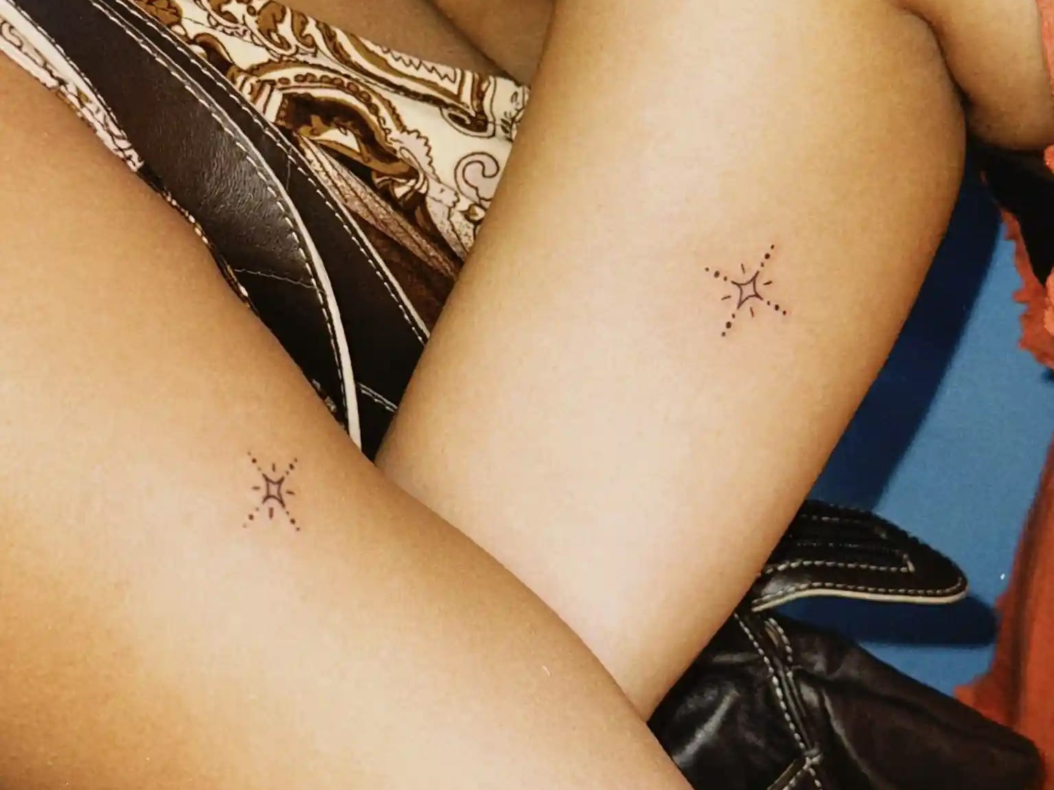a pair of matching buddy tattoos