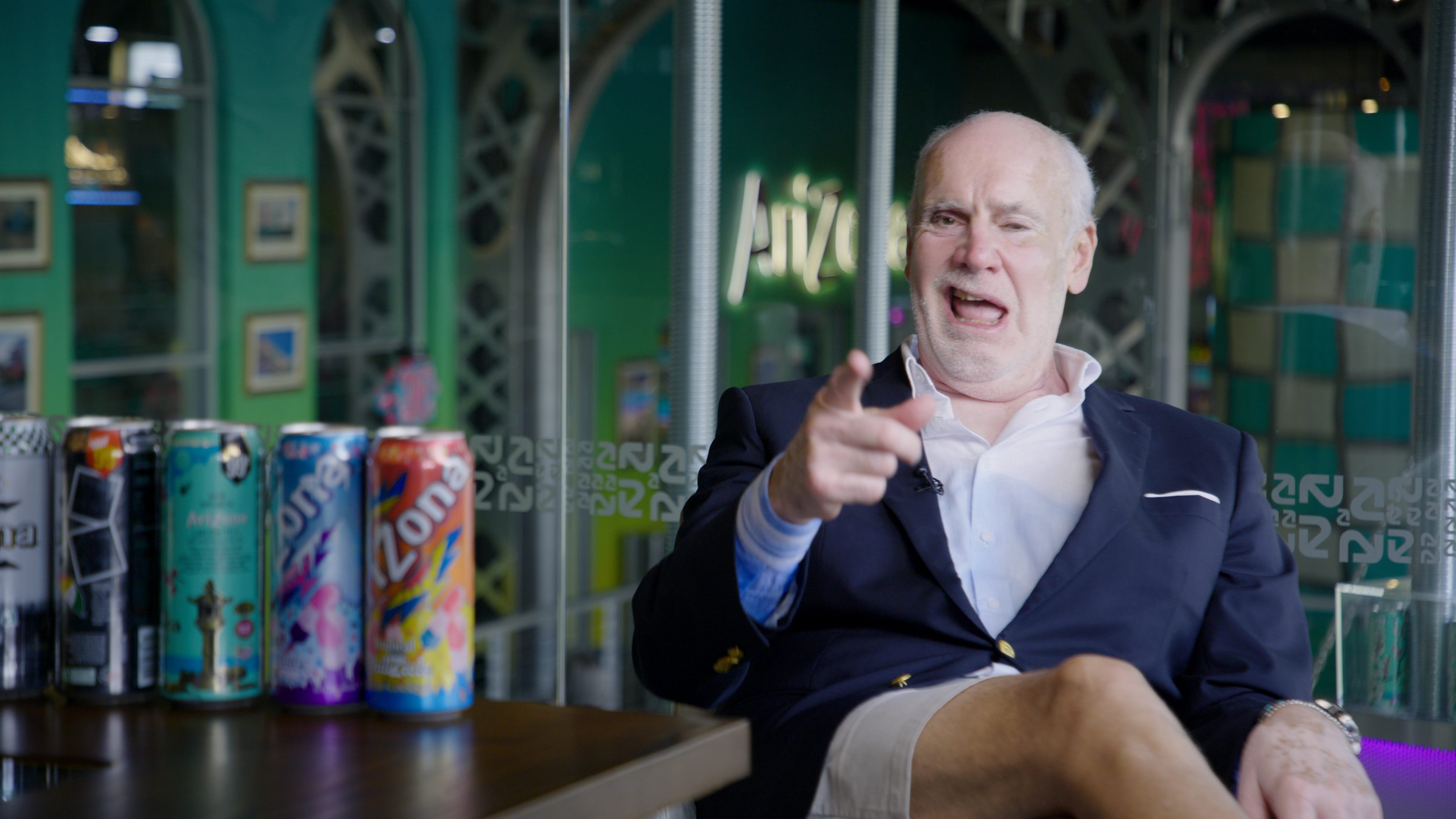 photo of Don Vultaggio in a blue blazer and tan shorts, pointing at the camera