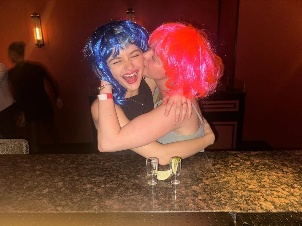 “Kissing Booth” star Joey King (in blue wig) and “Game of Thrones” alum Maisie Williams laugh it up while enjoying a night on the town full of shots and karaoke.

