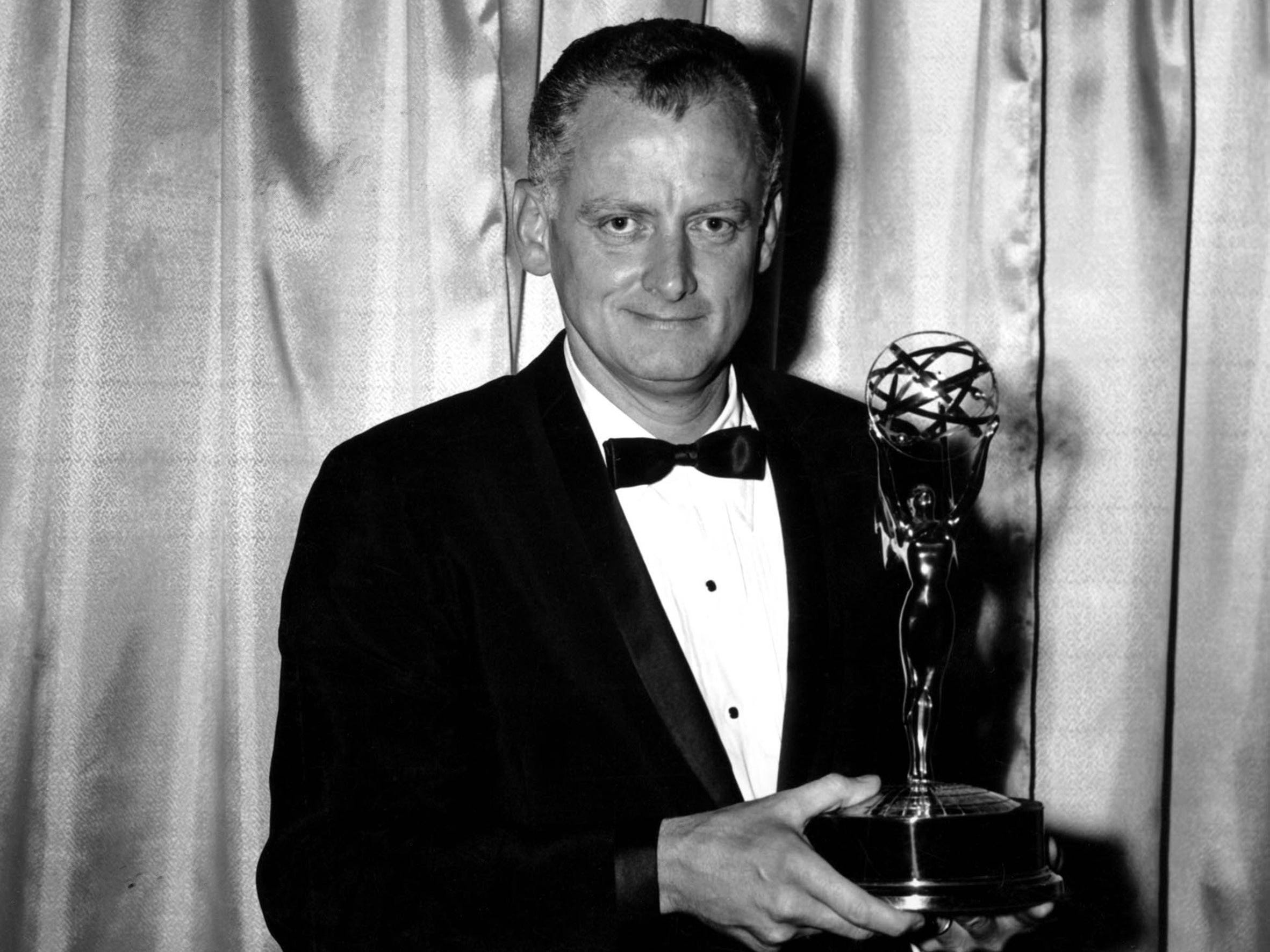 Art Carney holding his Emmy Award.