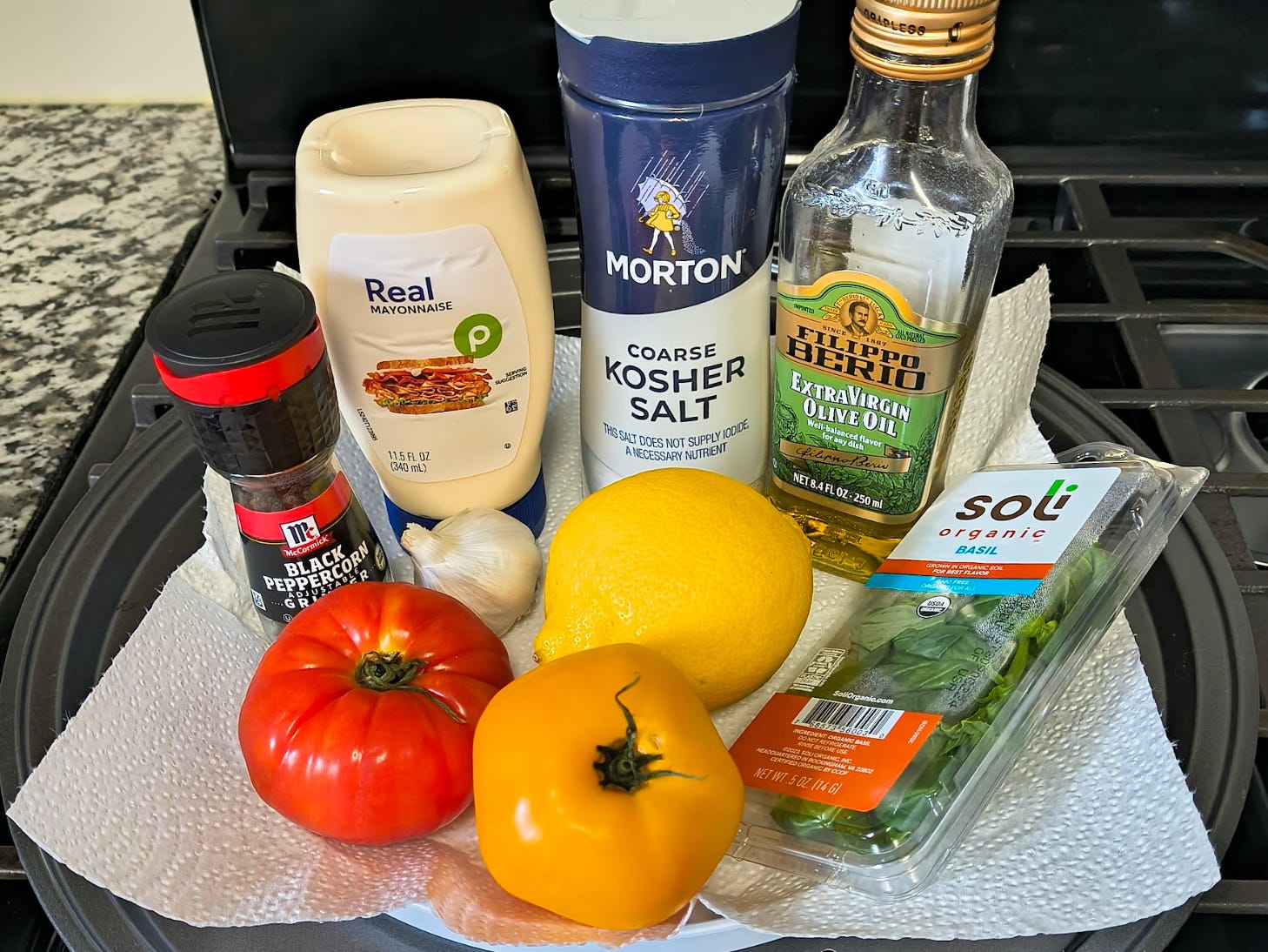Some of the ingredients needed for Ina Garten's tomato sandwich.