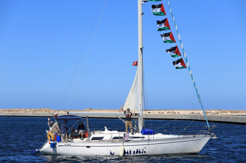 A sailboat carrying Palestinian flags departs from Tunisia for Gaza.