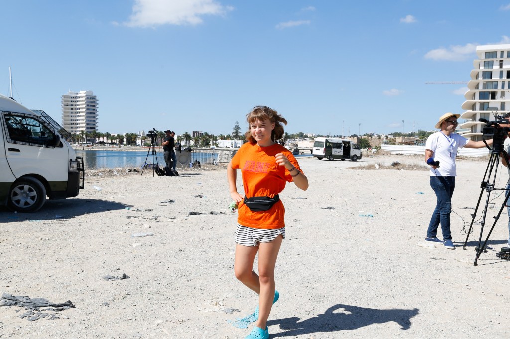Greta Thunberg walking at the port of Bizerte before setting sail for Gaza.