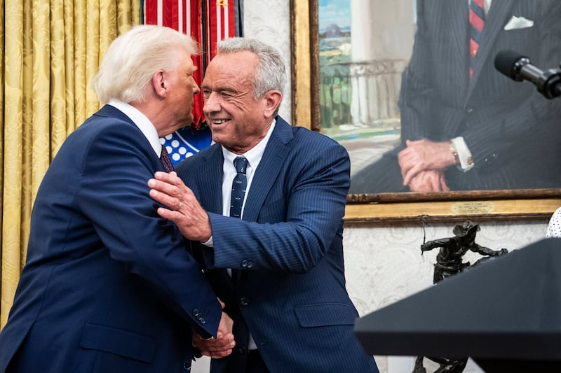 President Donald Trump congratulates Robert F. Kennedy Jr. after he was sworn in as Health and Human Services Secretary in the Oval Office at the White House on February 13, 2025 in Washington, D.C.