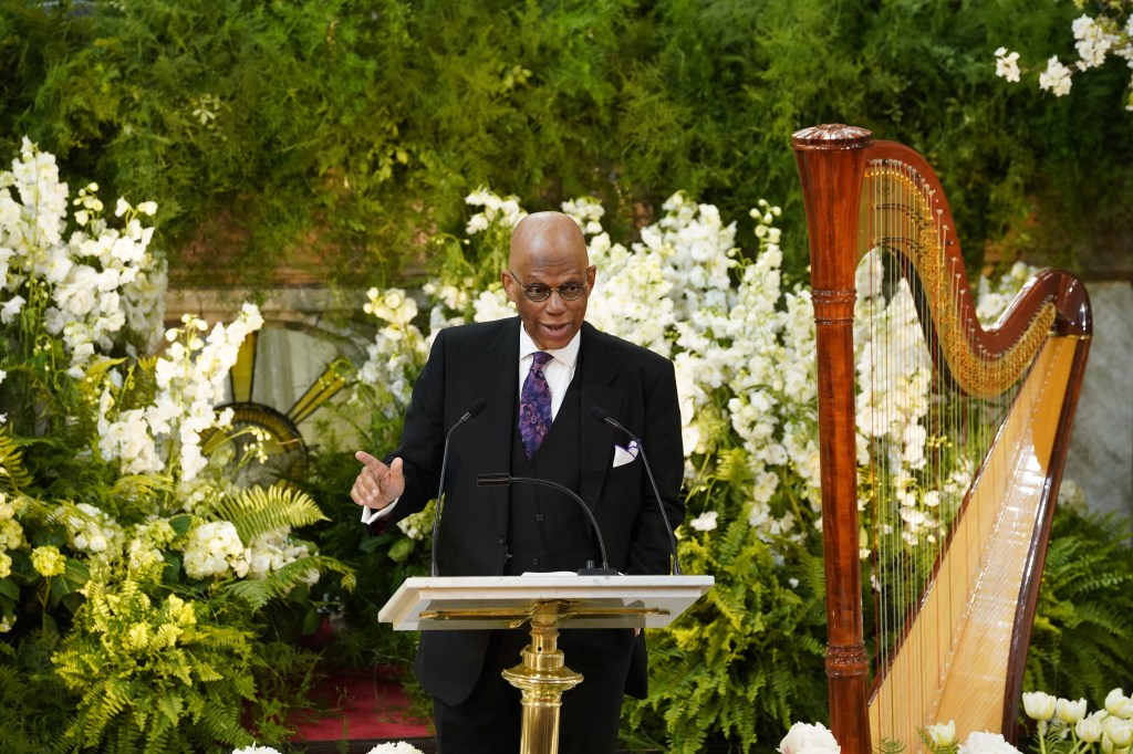 Rev. Dr. Calvin O. Butts III speaking at a podium.