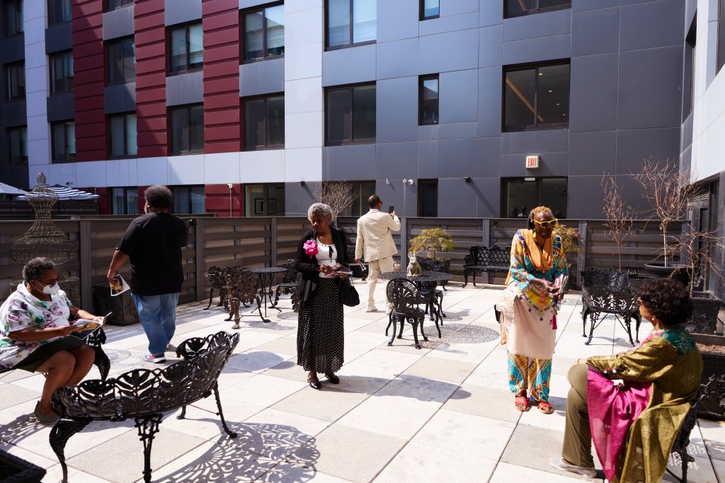 People gathered in the courtyard of the Dr. Calvin O. Butts III Educational and Cultural Center.