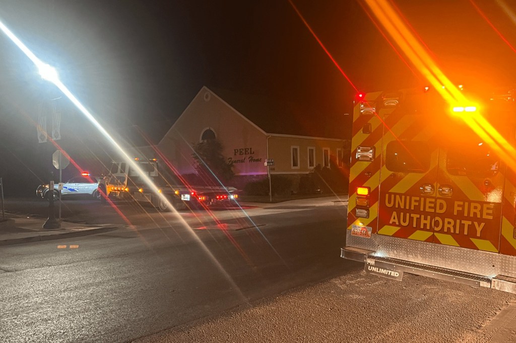 Emergency vehicles outside Peel Funeral Home at night.