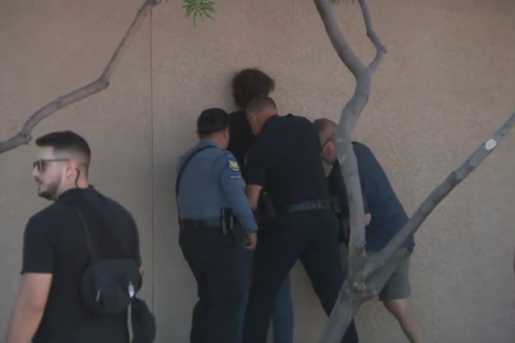 Police taking Corral in to custody after the vandalism.
