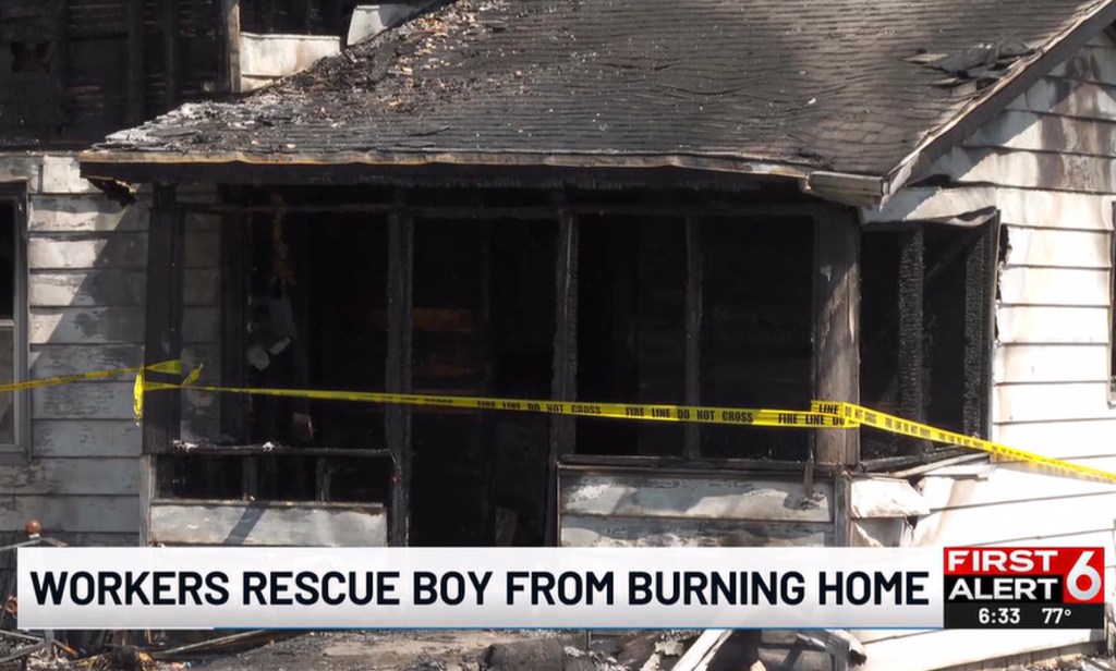 Fire-damaged house with police tape.