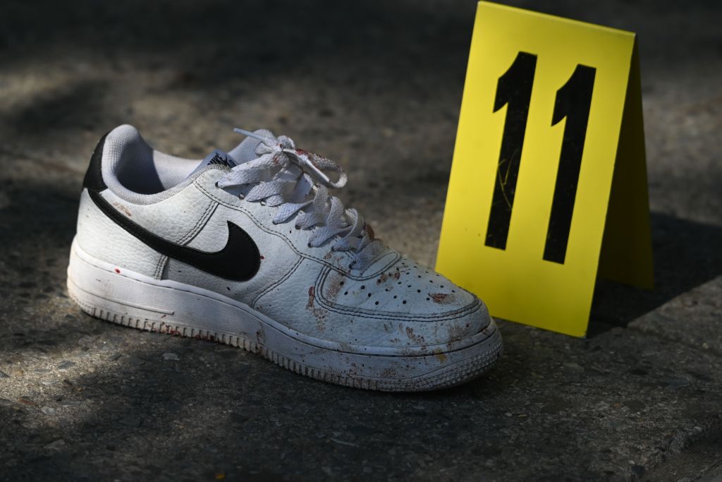 Bloodstained Nike shoe at a crime scene.
