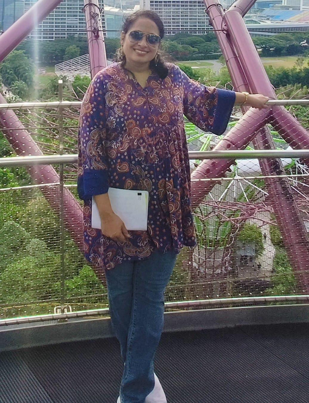 Sripriya Balasubramaniam wearing a purple blouse and blue jeans