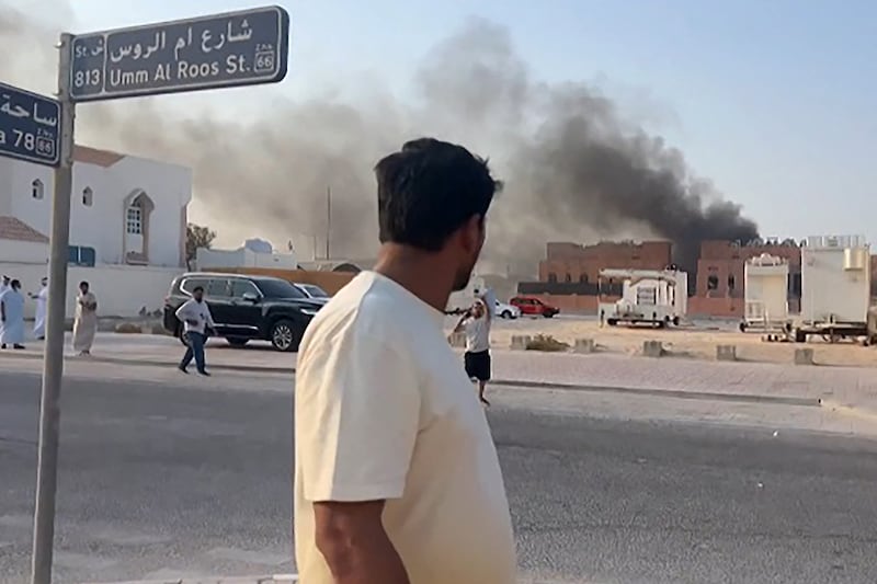 This frame grab taken from an AFPTV footage shows a man looking at smoke billowing after explosions in Qatar's capital Doha on September 9, 2025. An Israeli military official told AFP that the military had carried out air strikes on Doha on September 9 in an operation targeting senior leaders of Palestinian militant group Hamas. (Photo by Jacqueline PENNEY / AFPTV / AFP) (Photo by JACQUELINE PENNEY/AFPTV/AFP via Getty Images)