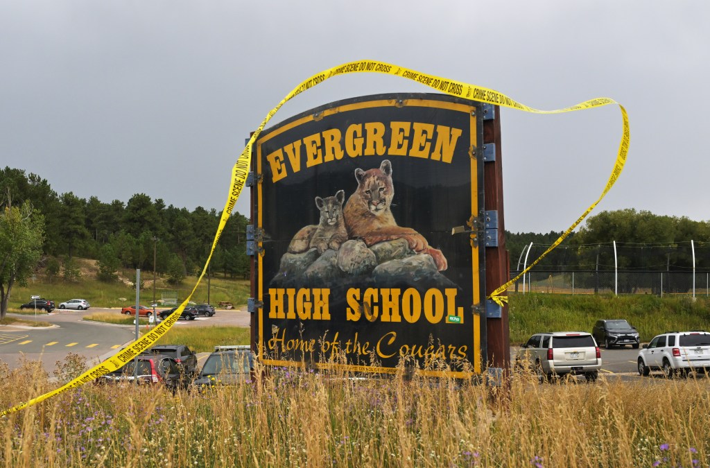 Evergreen High School sign with crime scene tape.