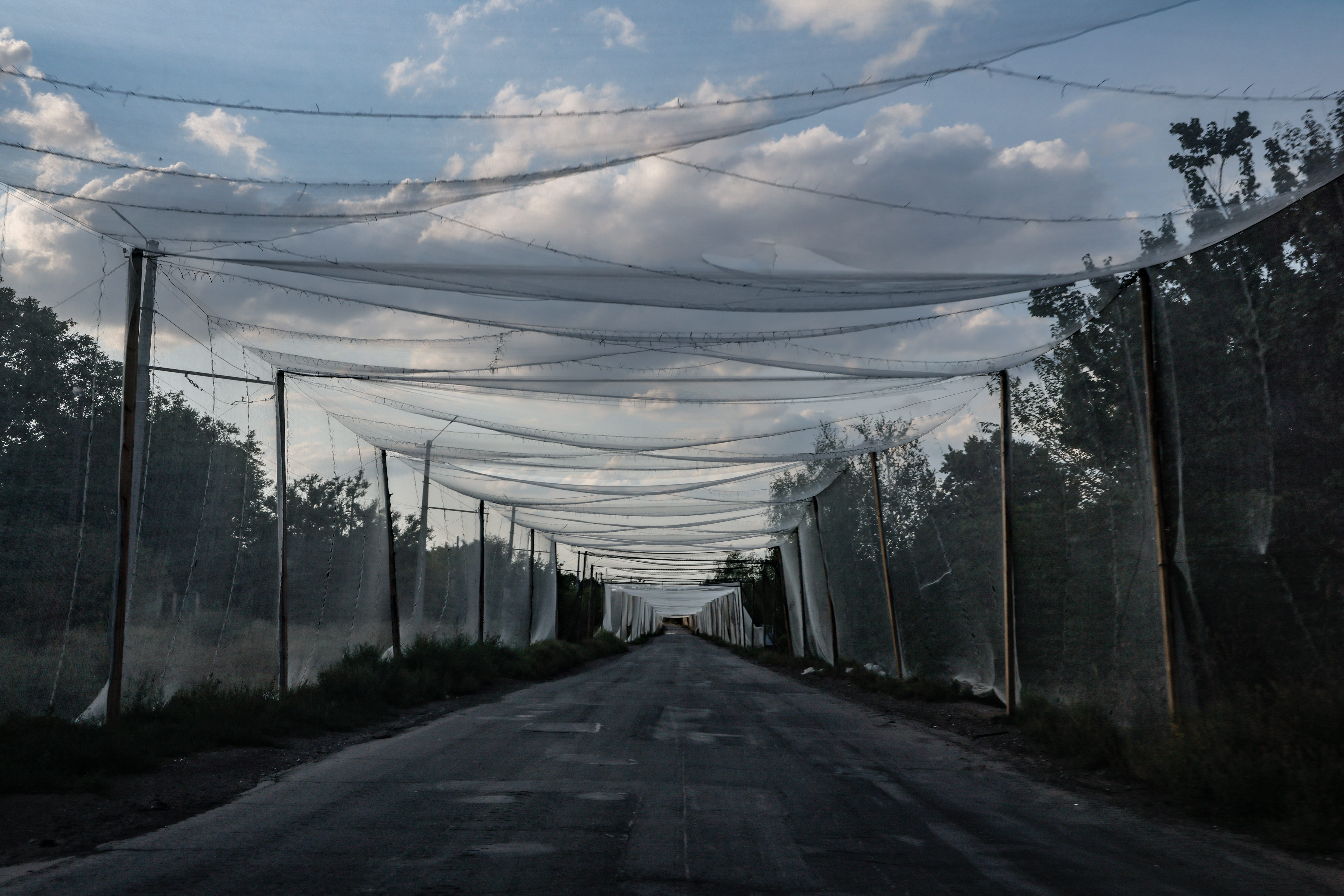An anti-drone net corridor stretches over the main road leading to the frontline town on August 24, 2025 in Kostiantynivka, Ukraine.