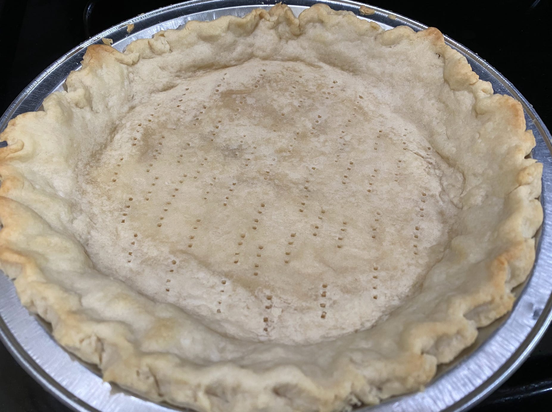 blind-baked empty pie shell in a pie tin