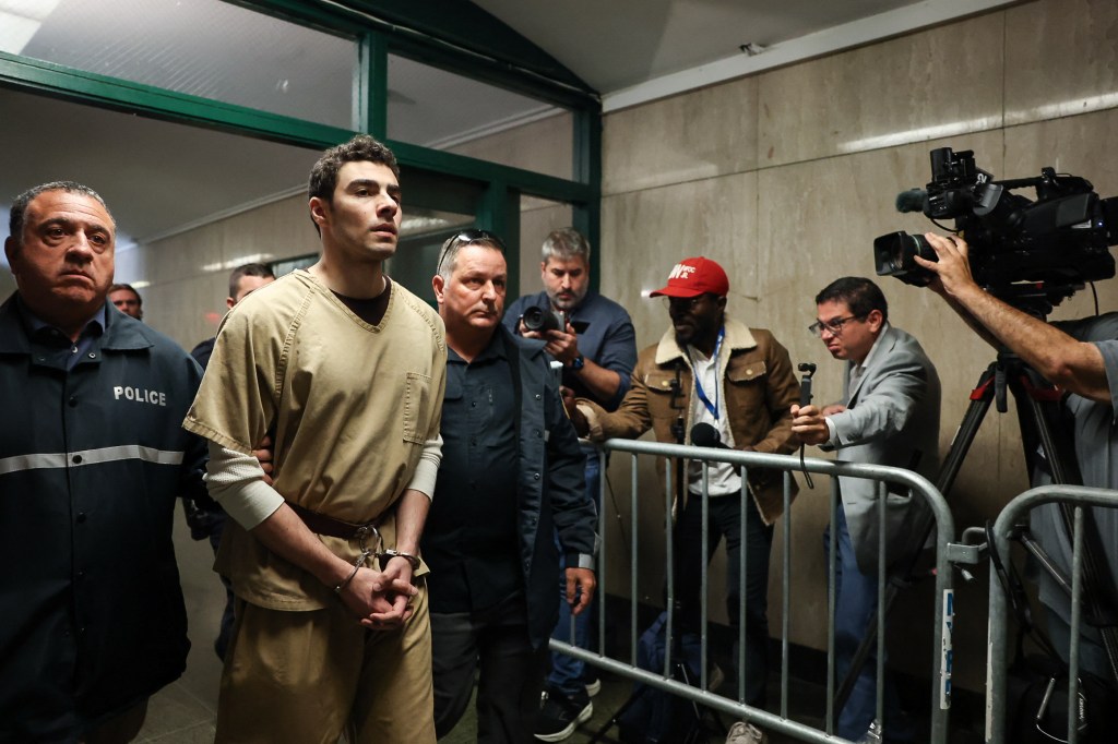Luigi Mangione, handcuffed and escorted by police, arrives at court.