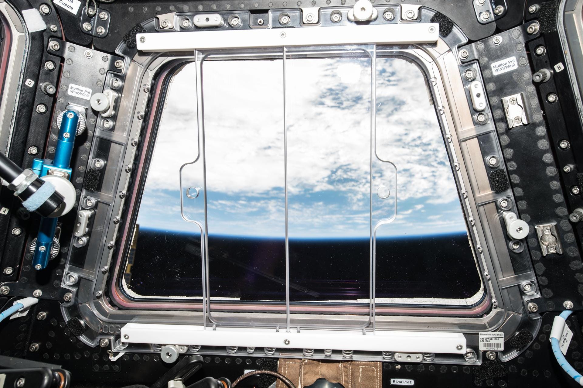 The cloudy Earth seen from a window on the ISS