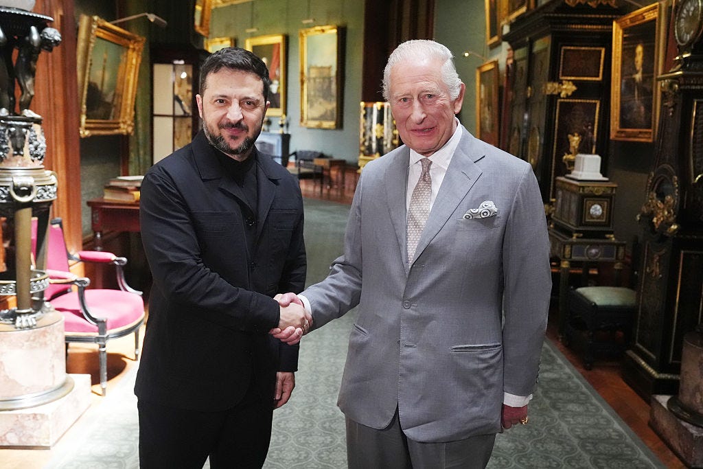Ukrainian President Volodymyr Zelenskyy shakes hands with King Charles III.