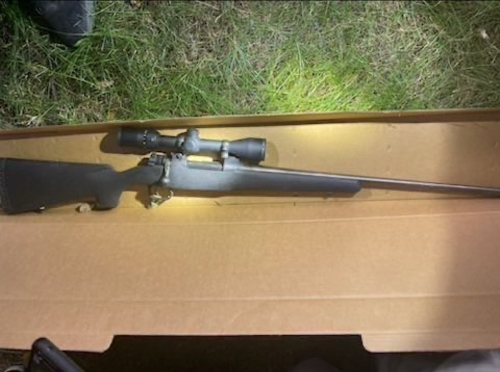 Bolt-action rifle in a box.