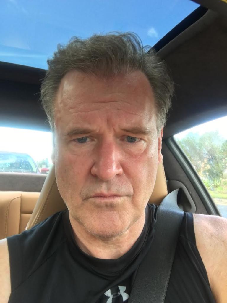 Self-portrait of a man in a car.