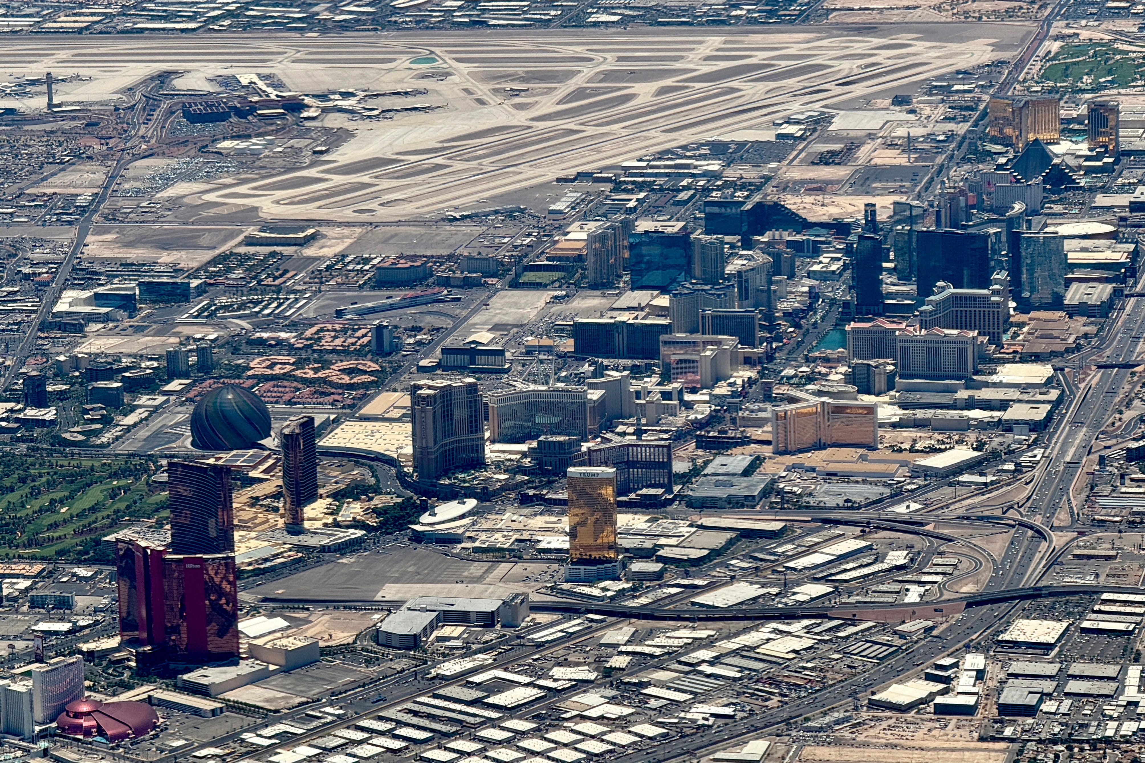 This aerial view taken on July 7, 2025 shows a view of the Las Vegas Strip and Harry Reid International Airport (LAS) (back).