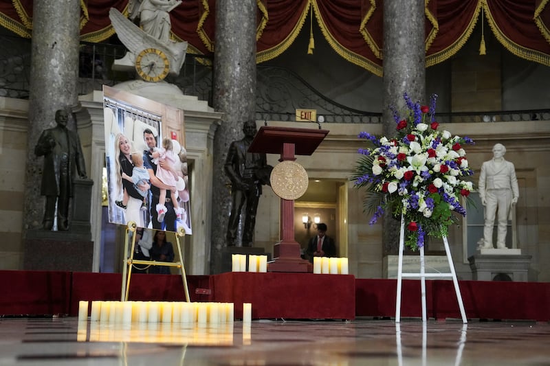 Candles and flowers are placed near an image of conservative activist Charlie Kirk with his family during a vigil in Statuary Hall at the U.S. Capitol in Washington, D.C. on September 15, 2025.