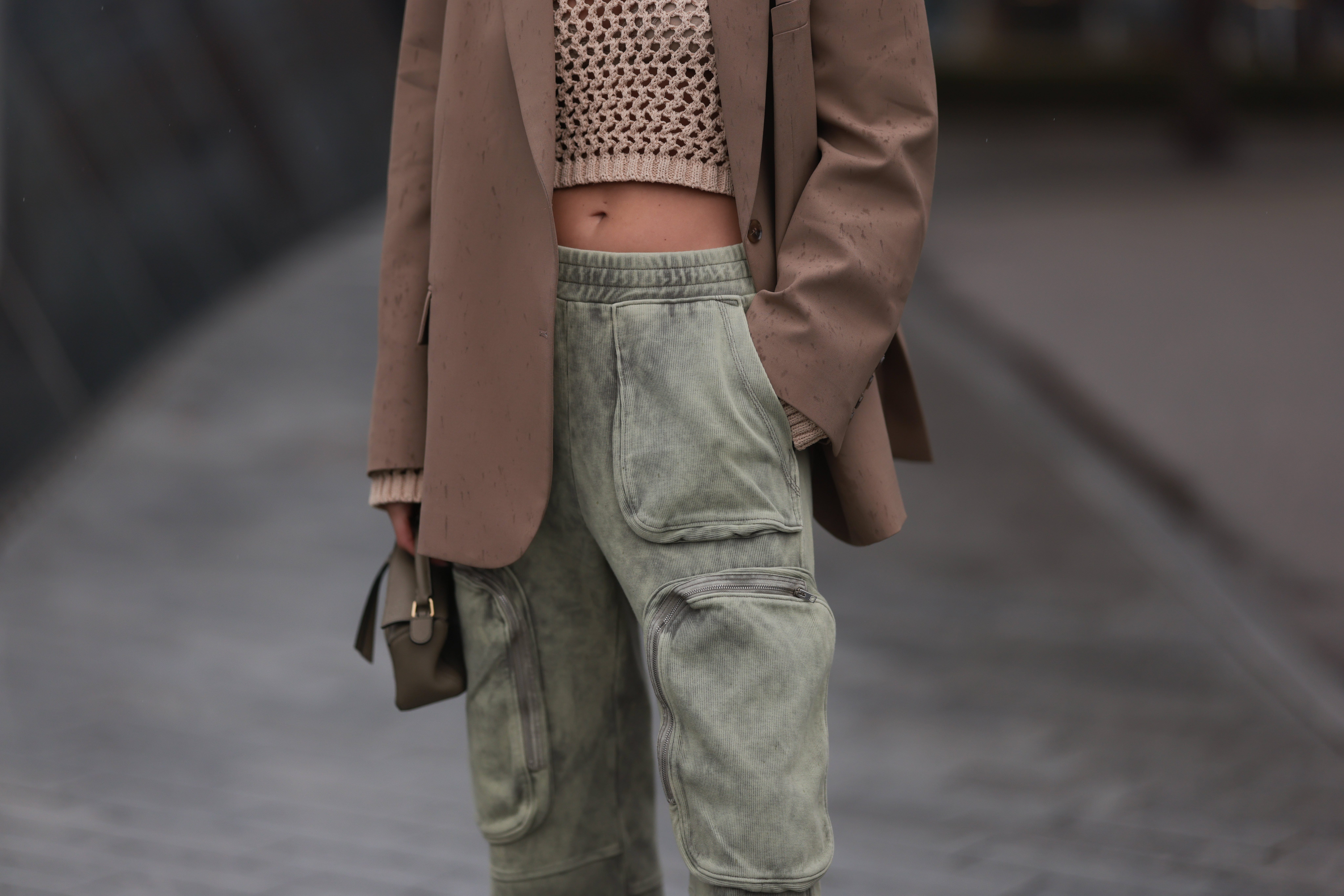 Person wearing blazer, crop top, and cargo joggers
