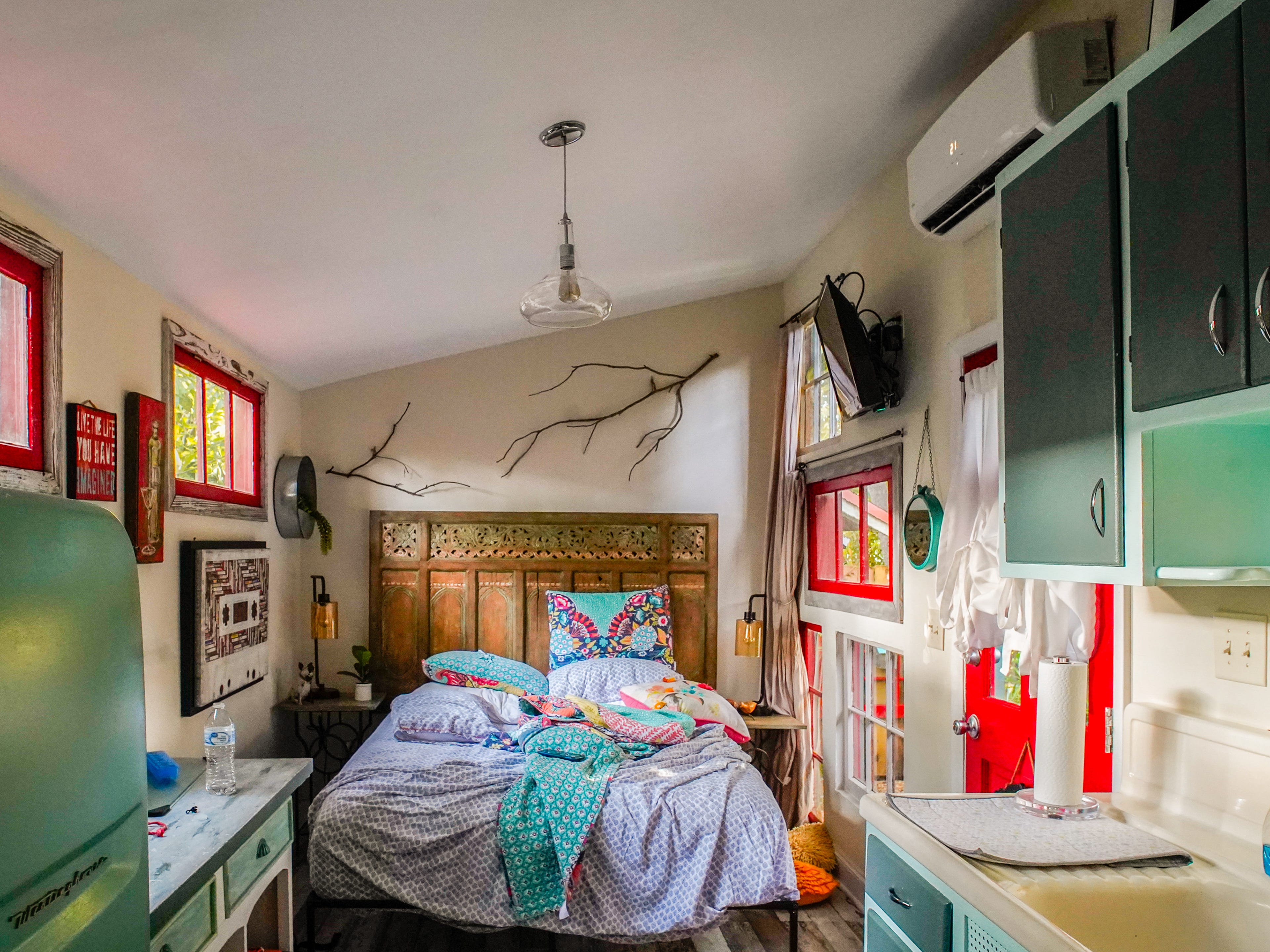 Inside a tiny home with an unmade bed