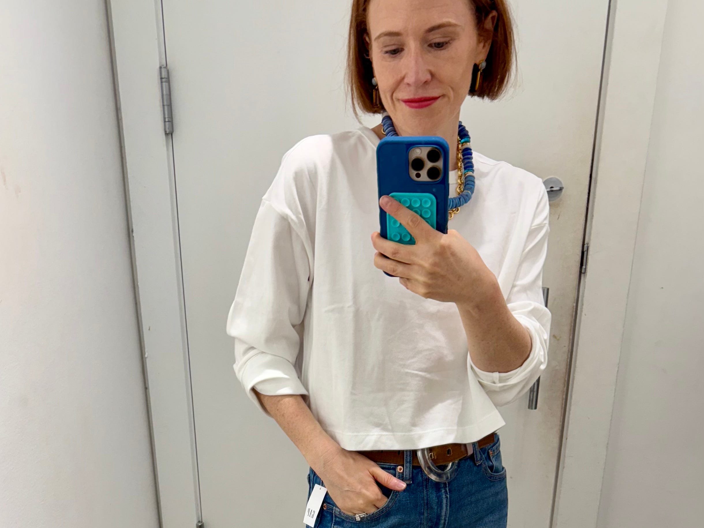 Author Grace Van Cleave wearing cropped tee and  jeans in Gap fitting room