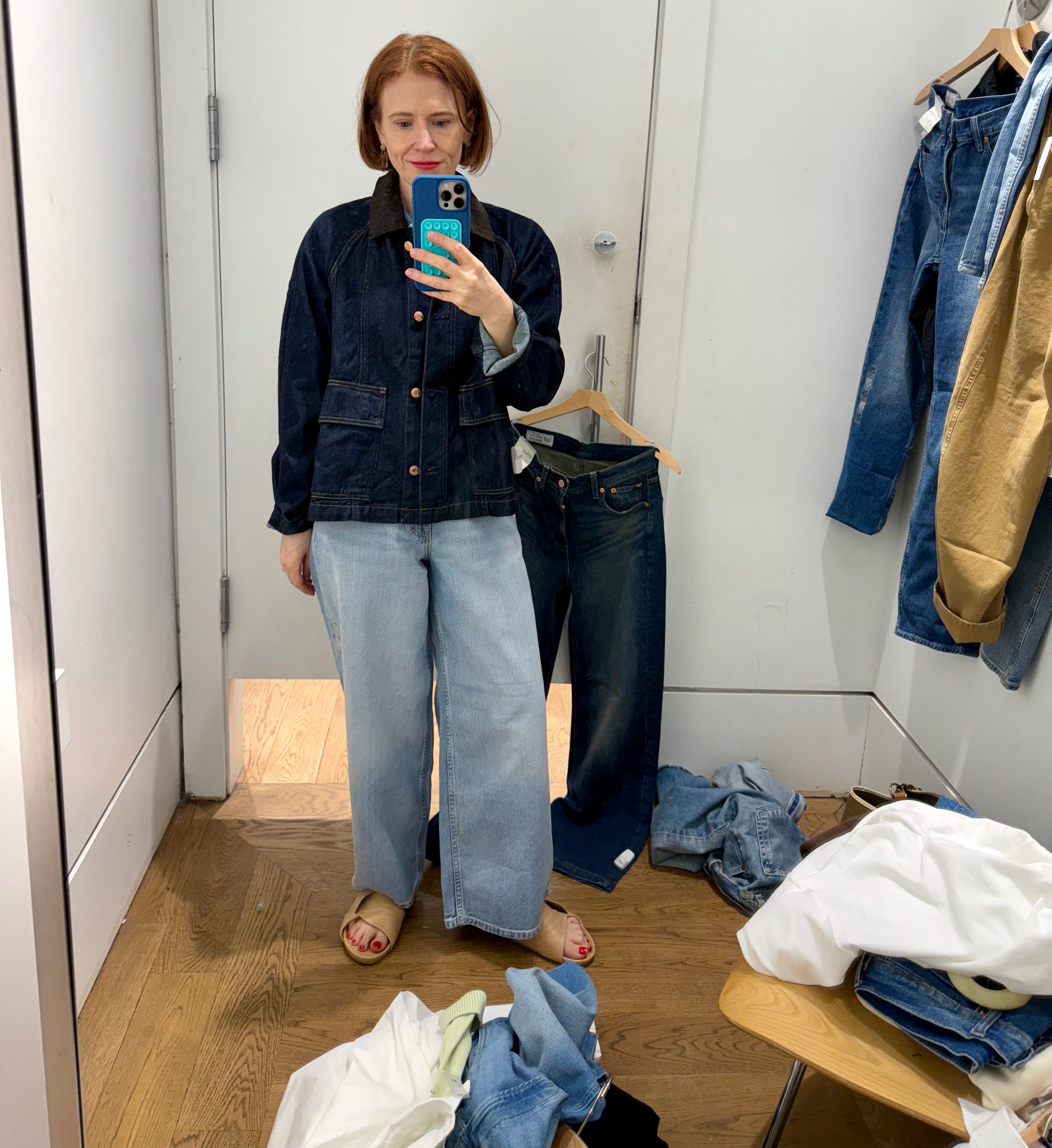 Author Grace Van Cleave wearing chore coat and baggy jeans in Gap fitting room