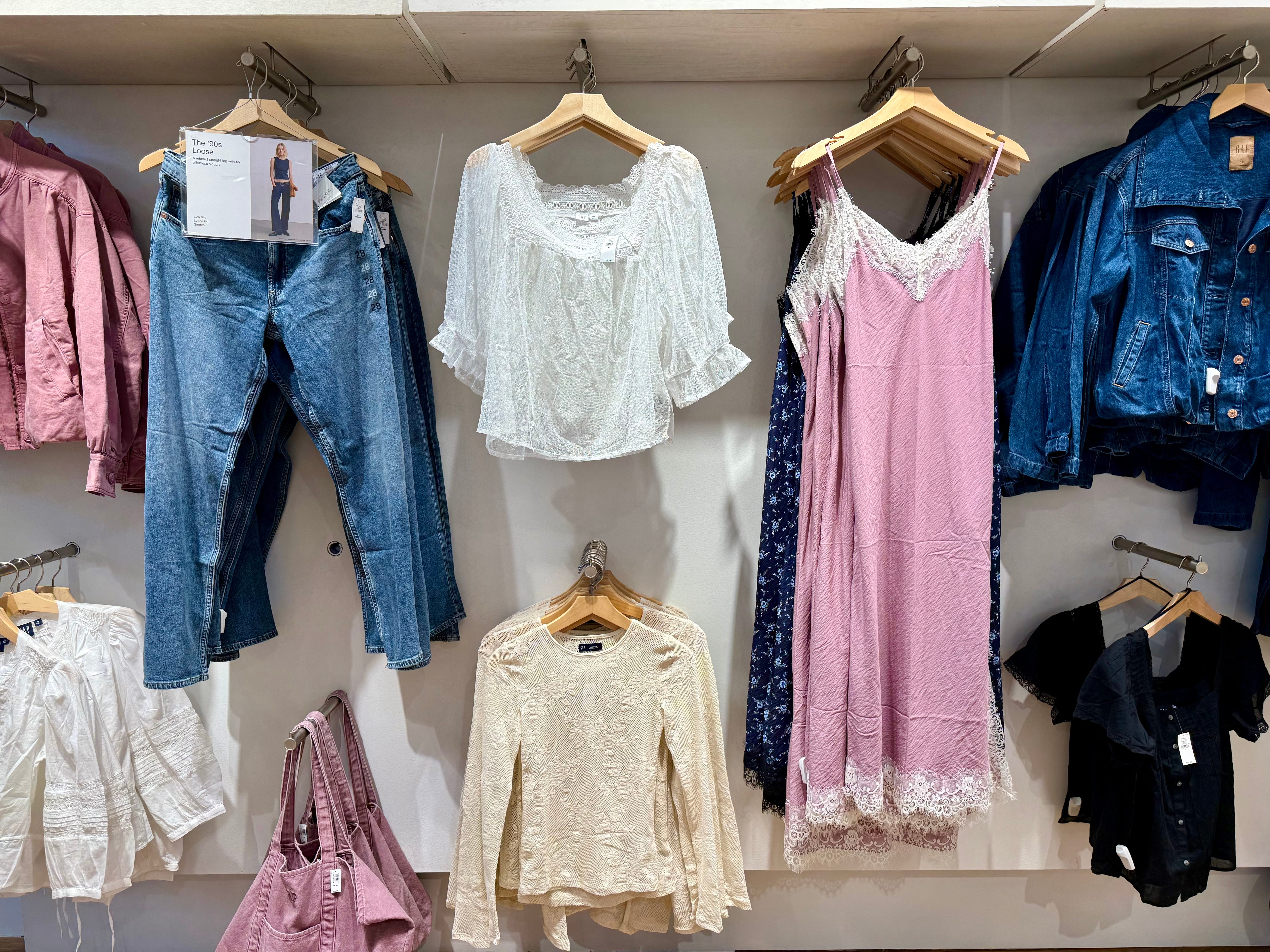 Slip dress, frilled tops, jeans on display in Gap store