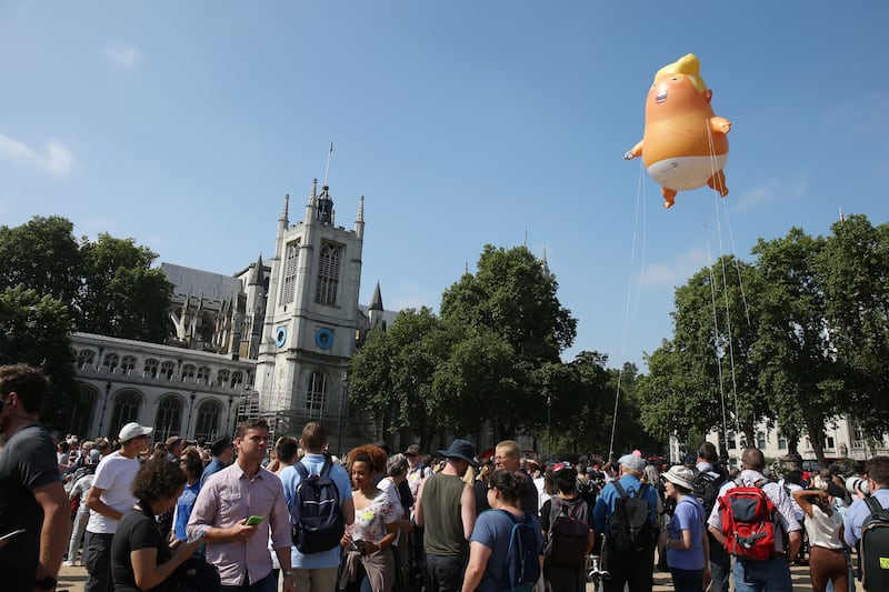 LONDON, UNITED KINGDOM - JULY 13:  The 'Trump Baby' blimp, a six meter-high helium-filled effigy of U.S. President Donald Trump, flies over Parliament Square in London, U.K. on Friday, July 13, 2018. Trump dealt a double blow to U.K. Prime Minister Theresa May, saying her plans for a soft Brexit would likely end hopes of a trade deal with the U.S. and that Boris Johnson, who quit her cabinet this week, would be a 'great' leader  (Photo by Neil Mockford/Getty Images)
