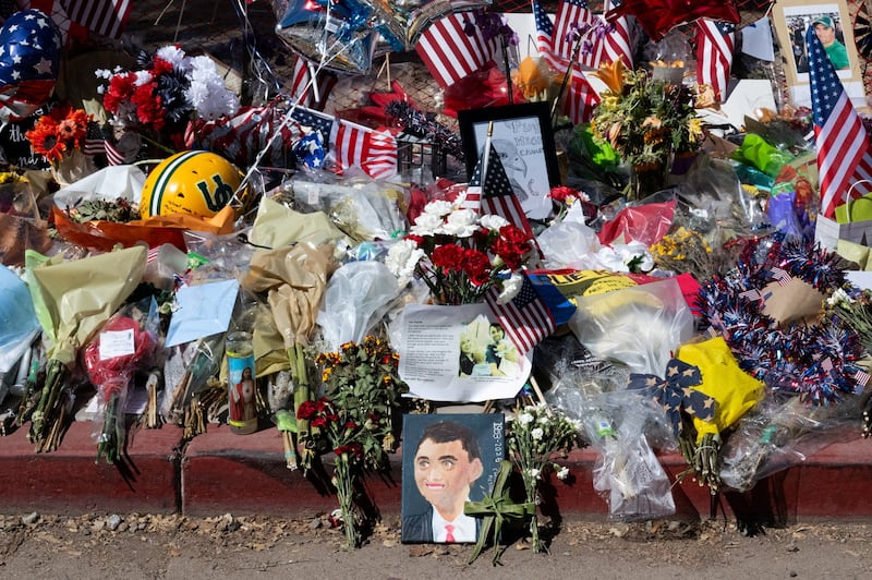 Flowers and handmade art are left as tributes in memory of conservative activist Charlie Kirk in Phoenix, Arizona on September 15, 2025.