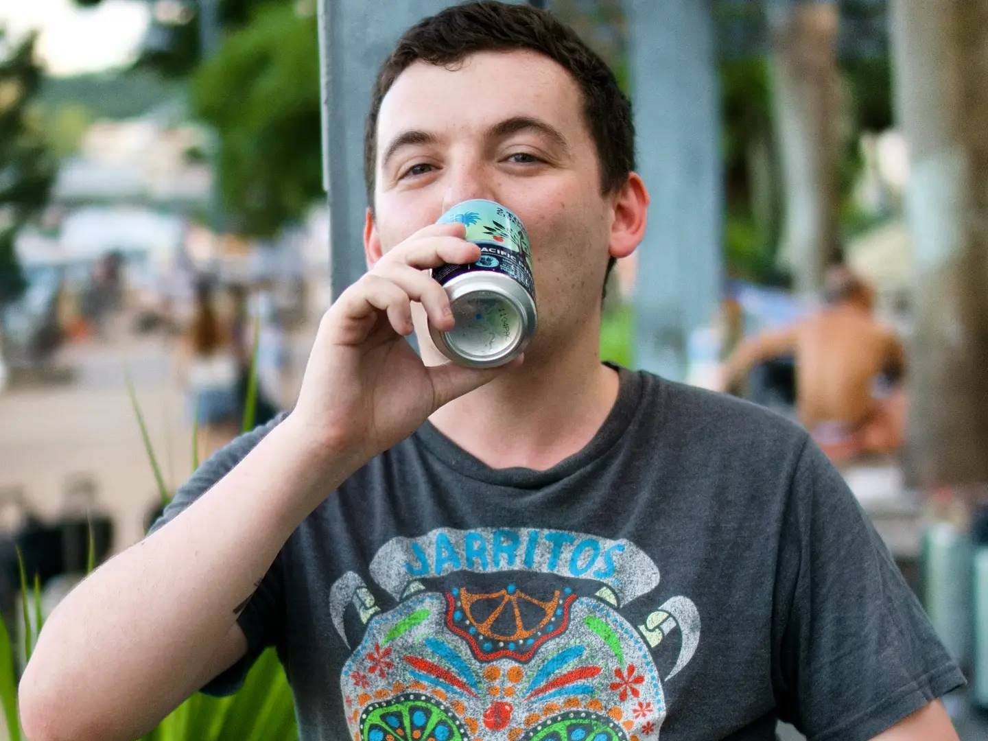 Nikolai Smirnoff drinking a bear near a beach in Hong Kong.