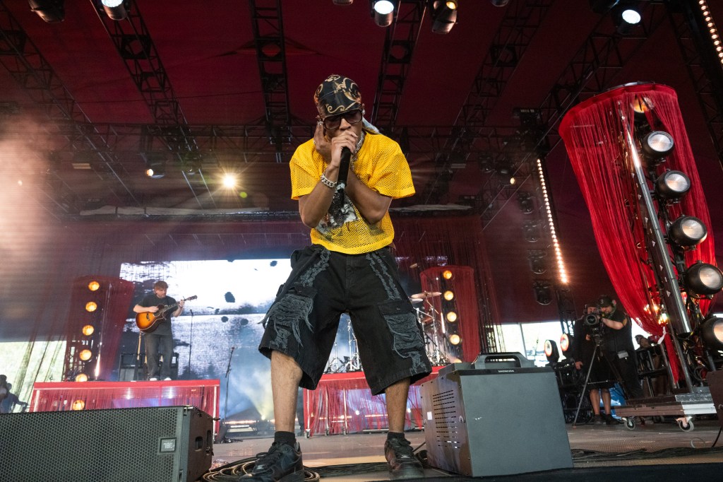 A performer singing into a microphone on stage.