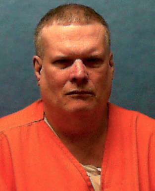 Mugshot of a man in an orange jumpsuit.