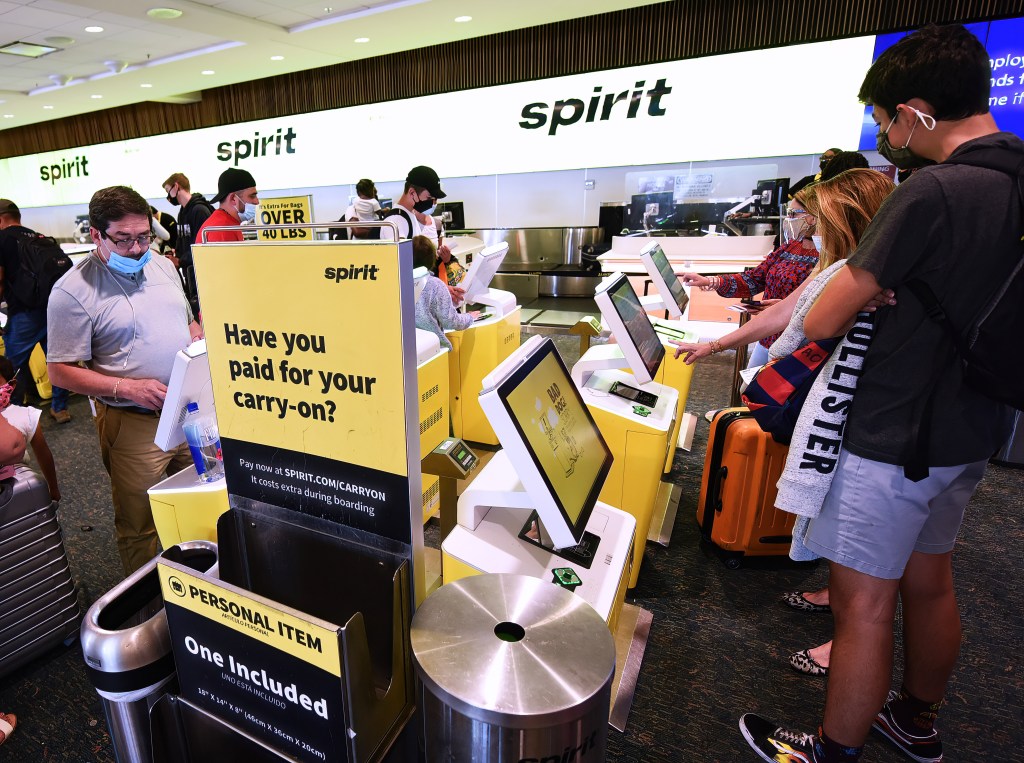 Passengers checking in for a Spirit Airlines flight at Orlando airport.