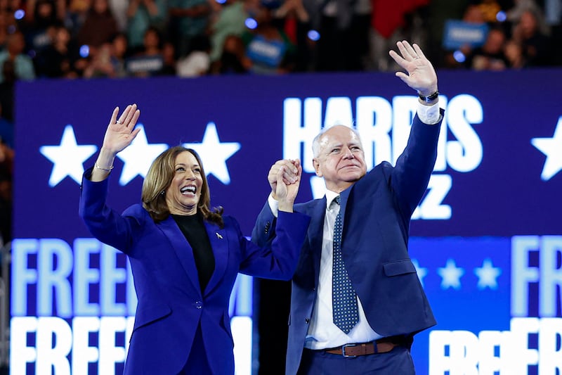 Kamala Harris and her running mate Minnesota Governor Tim Walz wave to the crowd after speaking at the campaign rally at the Fiserv Forum in Milwaukee, Wisconsin, August 20, 2024.