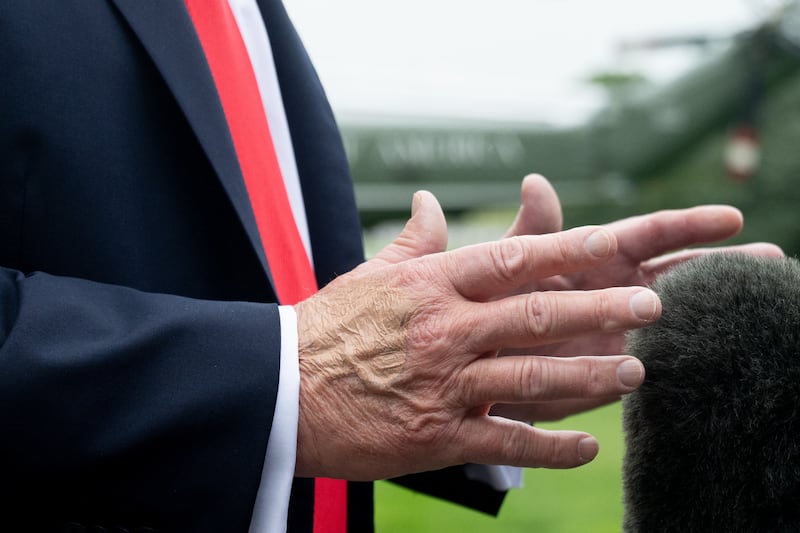 US President Donald Trump gestures with his hands as he speaks to the press prior to boarding Marine One as he departs from the South Lawn of the White House in Washington, DC, on September 16.