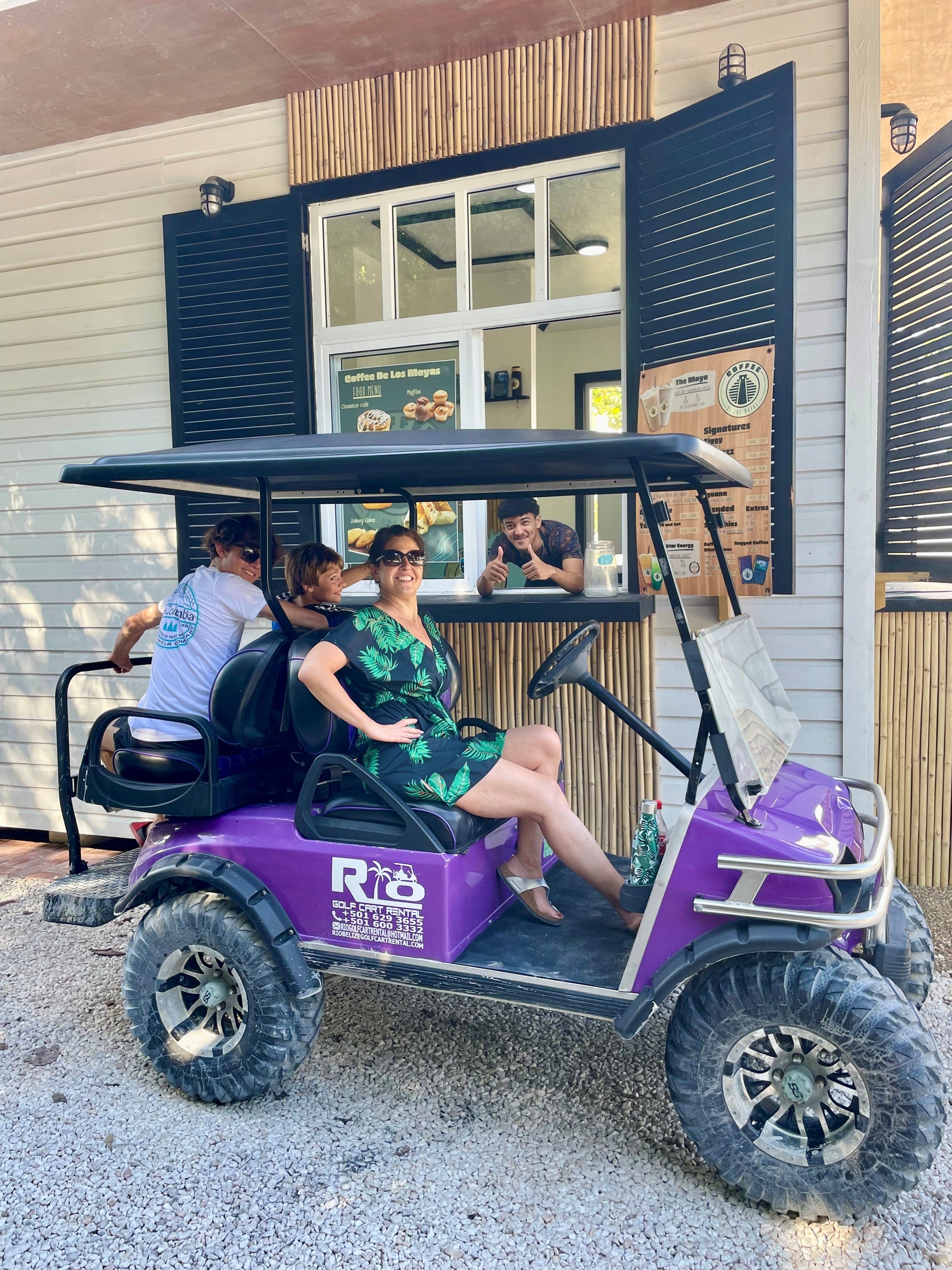 Author Christina Valhouli in golf cart driving through coffee shop