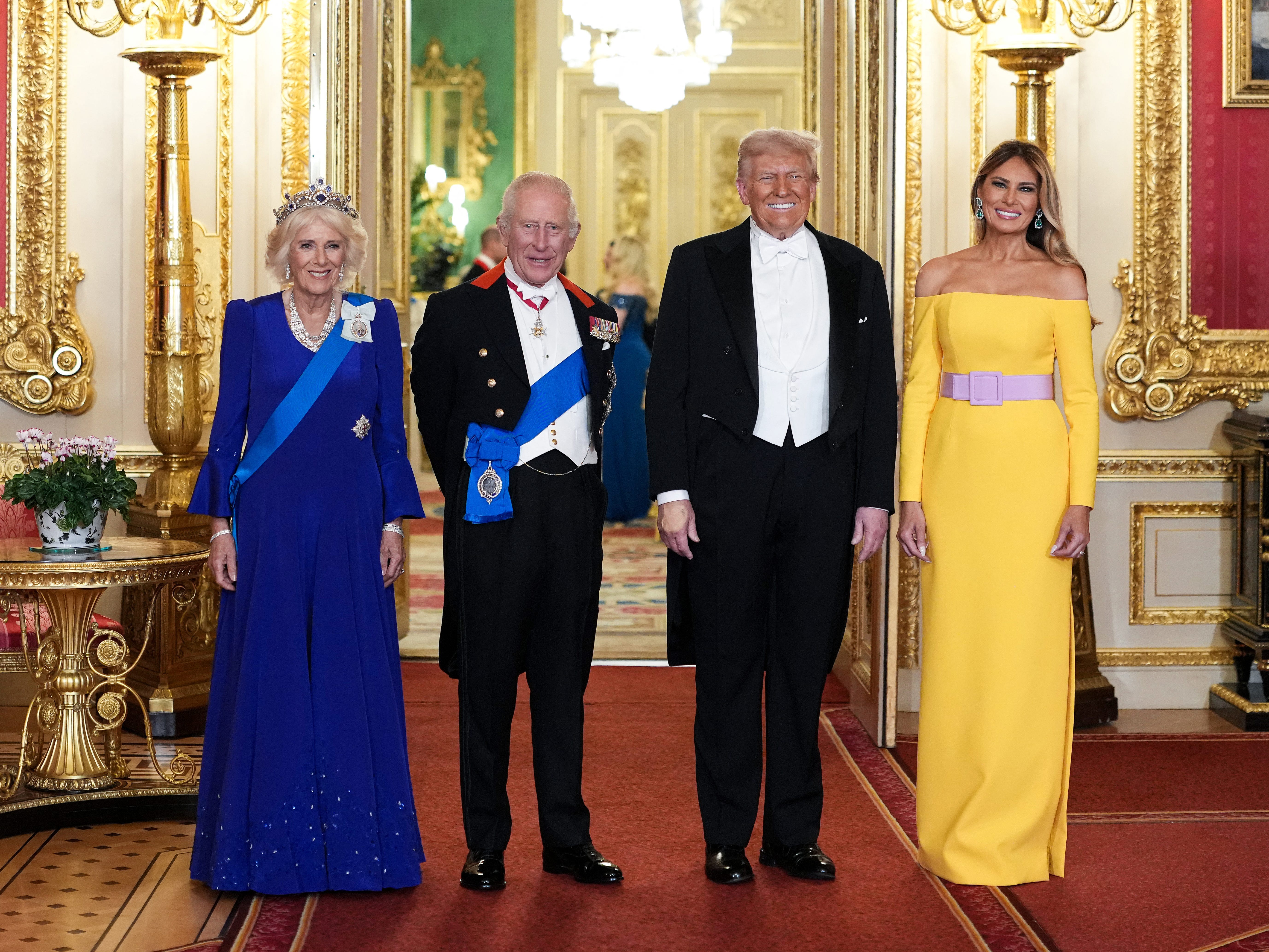 Queen Camilla, King Charles, Donald Trump, and Melania Trump standing side-by-side in an ornately decorated room.