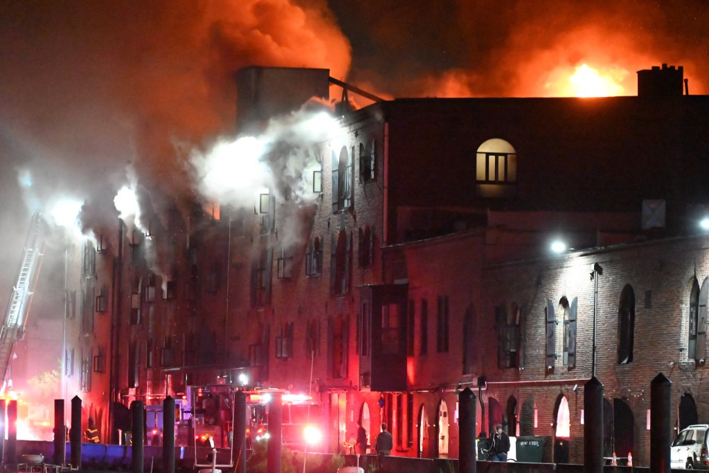 FDNY firefighters battling a three-alarm fire at a commercial and residential building in Brooklyn.
