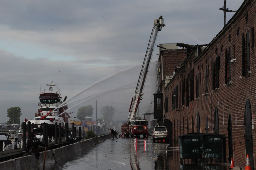 Firefighters extinguishing a warehouse fire.