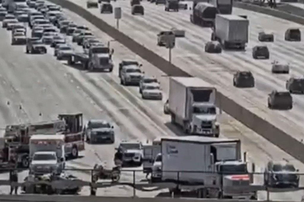 Highway traffic jam with emergency vehicles.