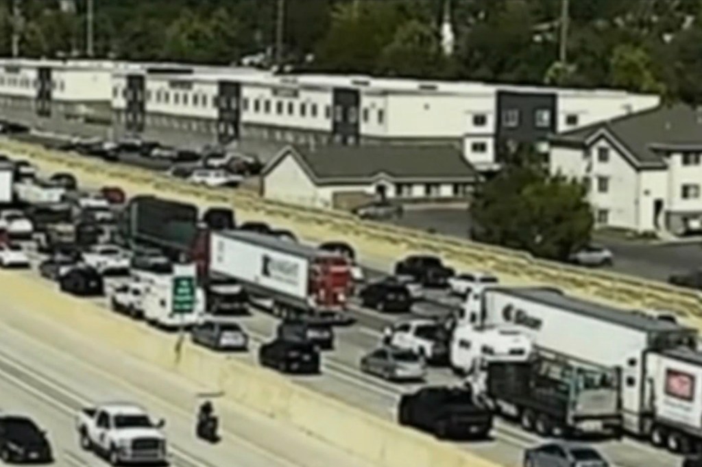 Highway traffic jam near a building.