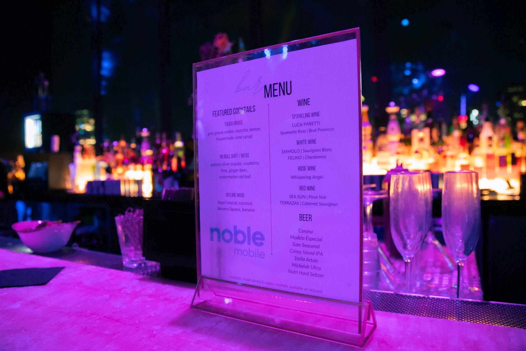 A menu stands on display on a bar counter.