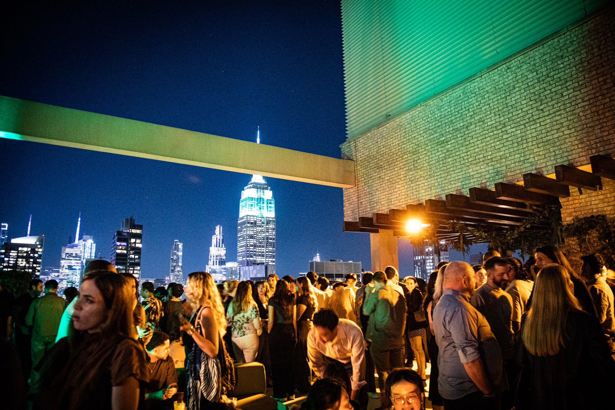 The Manhattan skyline seen from a rooftop party.